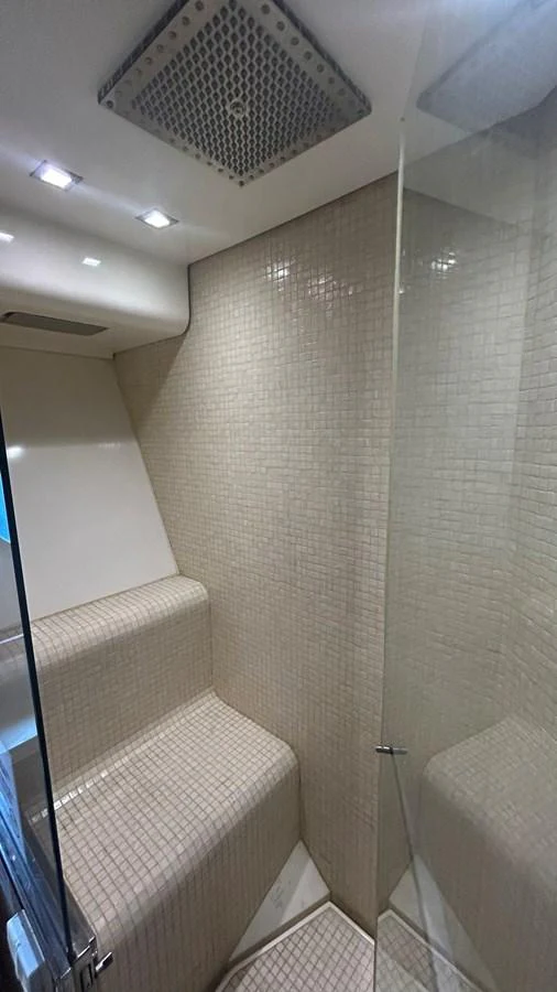 A luxurious yacht shower with modern fixtures and elegant tiling. aboard AURORA Yacht for Sale