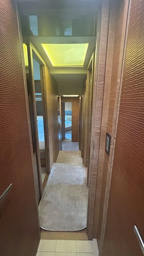 A sleek and modern hallway with wooden paneling and soft lighting. aboard AURORA Yacht for Sale