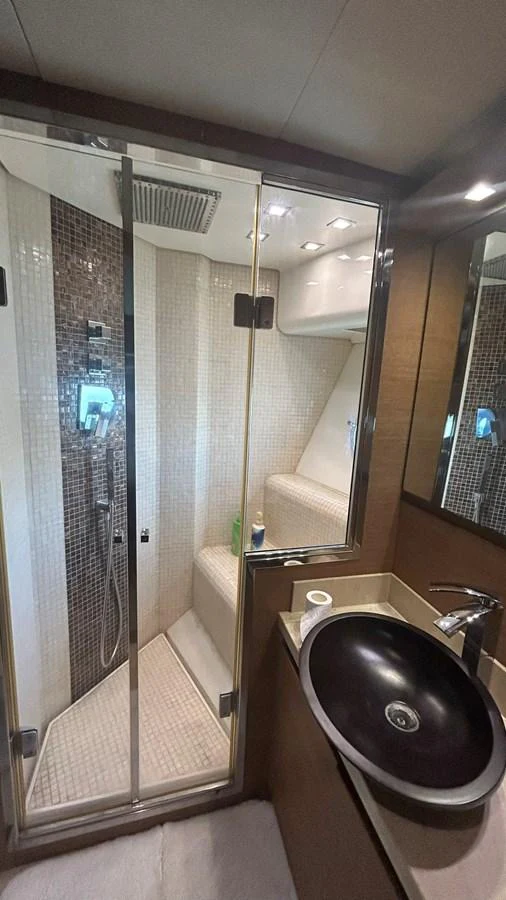 The yacht's bathroom features a modern shower and sleek fixtures. aboard AURORA Yacht for Sale