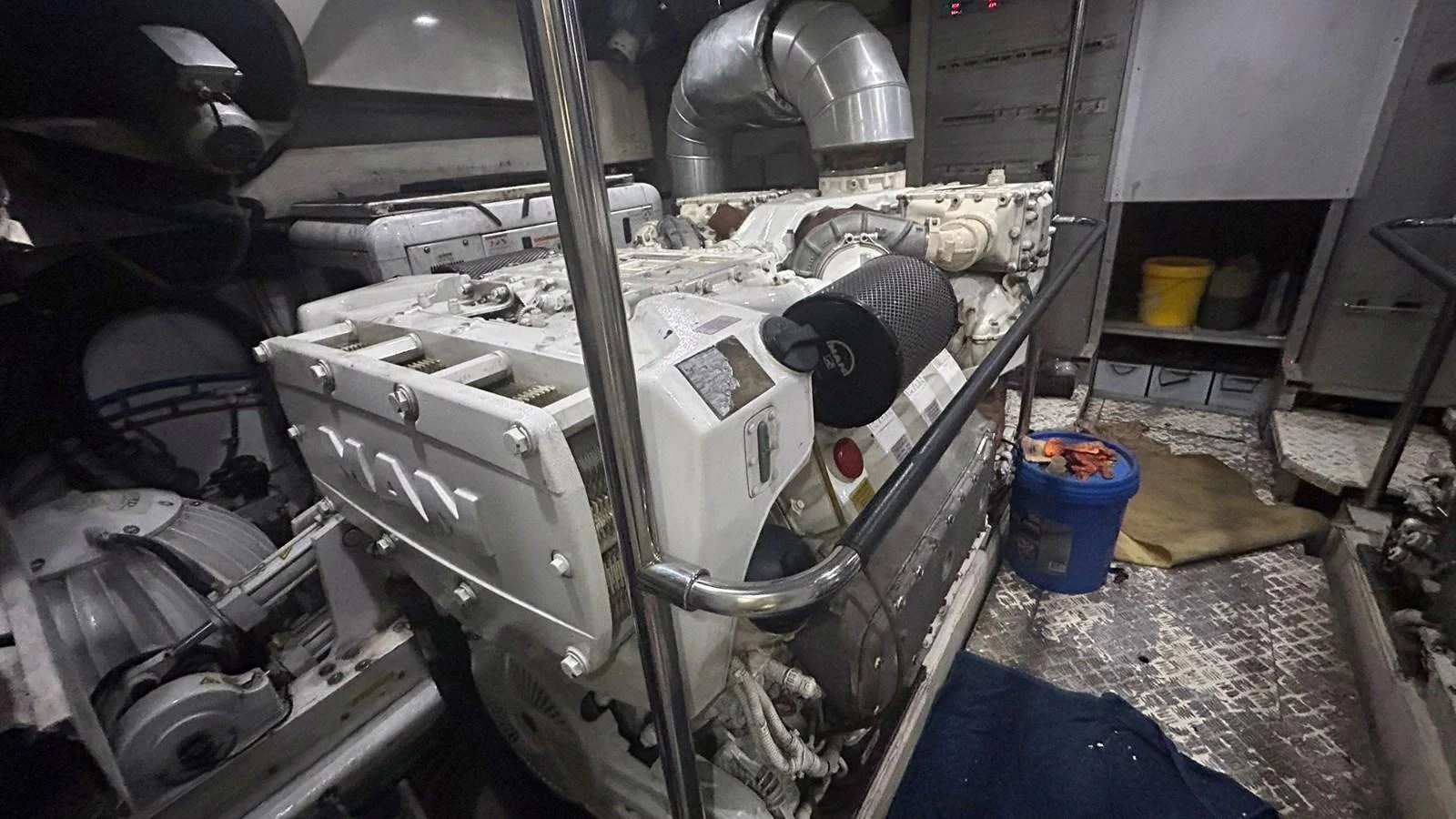 The image showcases the engine room with a powerful engine and various mechanical components. aboard AURORA Yacht for Sale