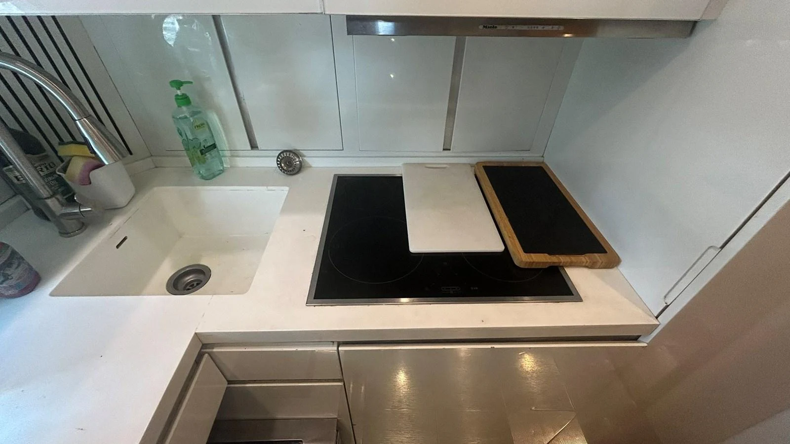 The yacht's galley features a sleek, modern design with a built-in stovetop and sink. aboard AURORA Yacht for Sale