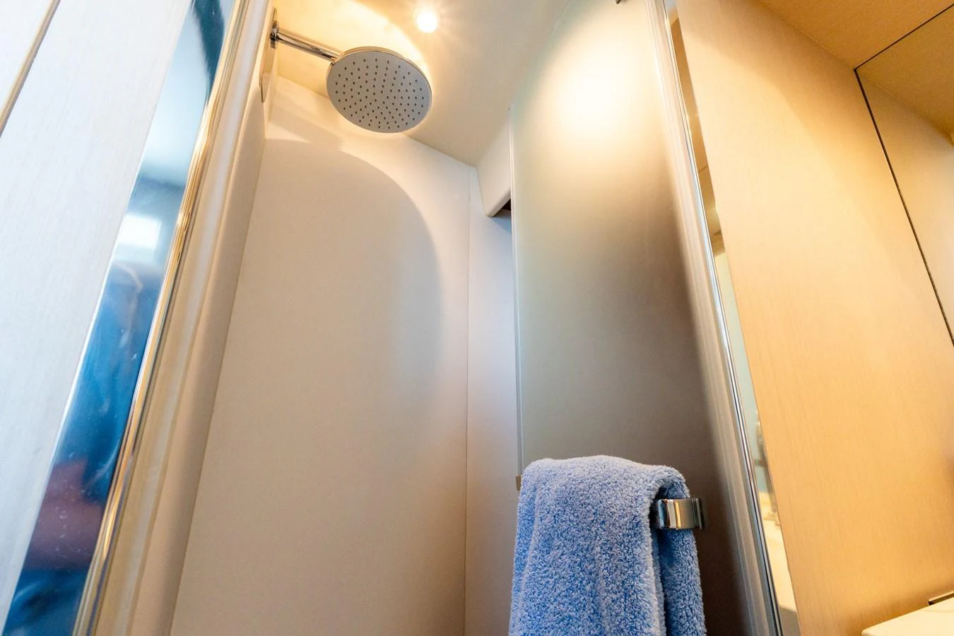 A modern yacht bathroom with a sleek shower and soft lighting. aboard GONE PHISHING Yacht for Sale
