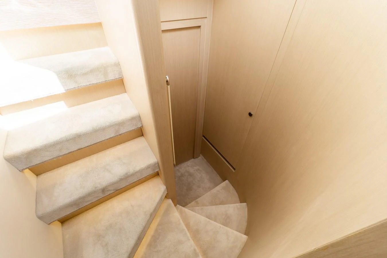 A well-lit staircase with plush carpeting leads to the lower deck. aboard GONE PHISHING Yacht for Sale