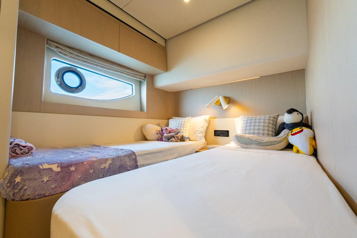 A cozy guest cabin with twin beds and soft lighting. aboard GONE PHISHING Yacht for Sale
