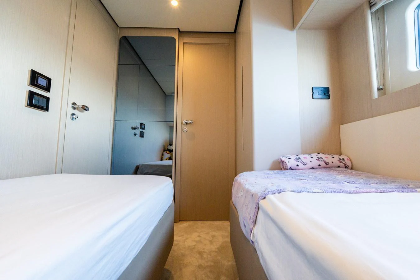 The twin stateroom features two single beds with a modern, minimalist design. aboard GONE PHISHING Yacht for Sale
