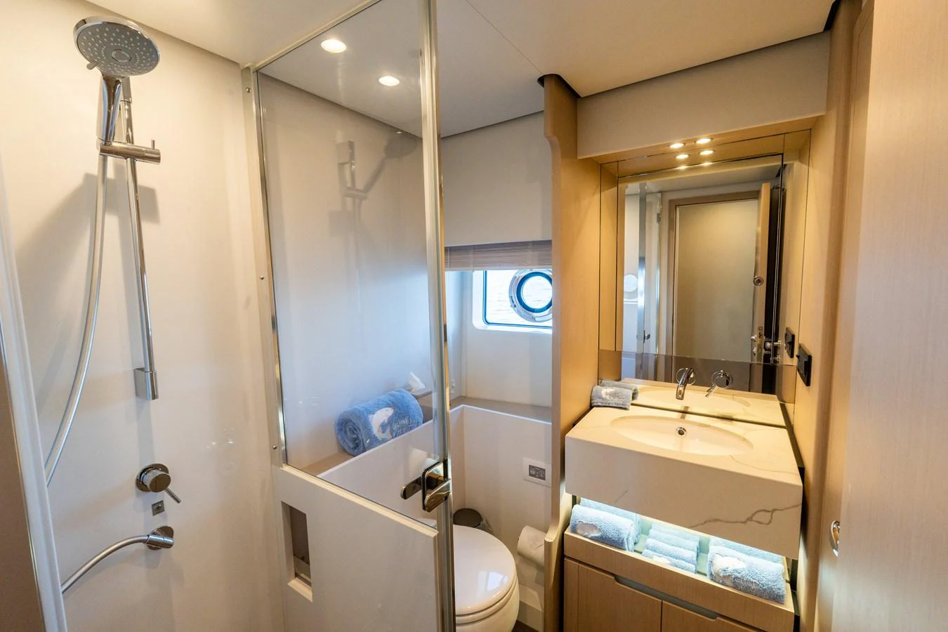 The yacht's bathroom features a modern shower, sleek sink, and ample lighting. aboard GONE PHISHING Yacht for Sale