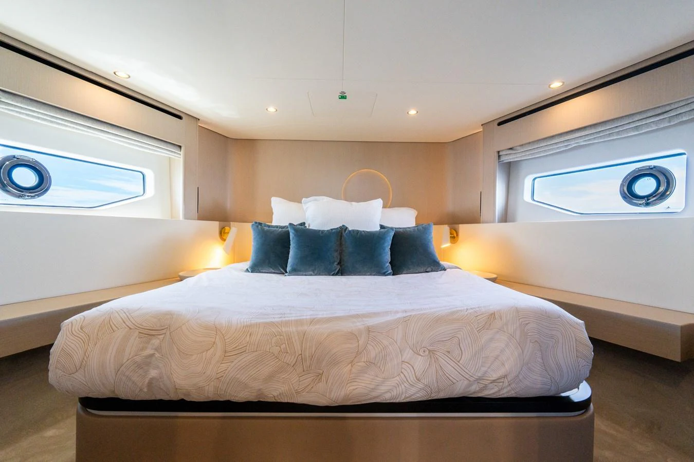 The master stateroom features a spacious bed with elegant bedding and ample natural light from the side windows. aboard GONE PHISHING Yacht for Sale