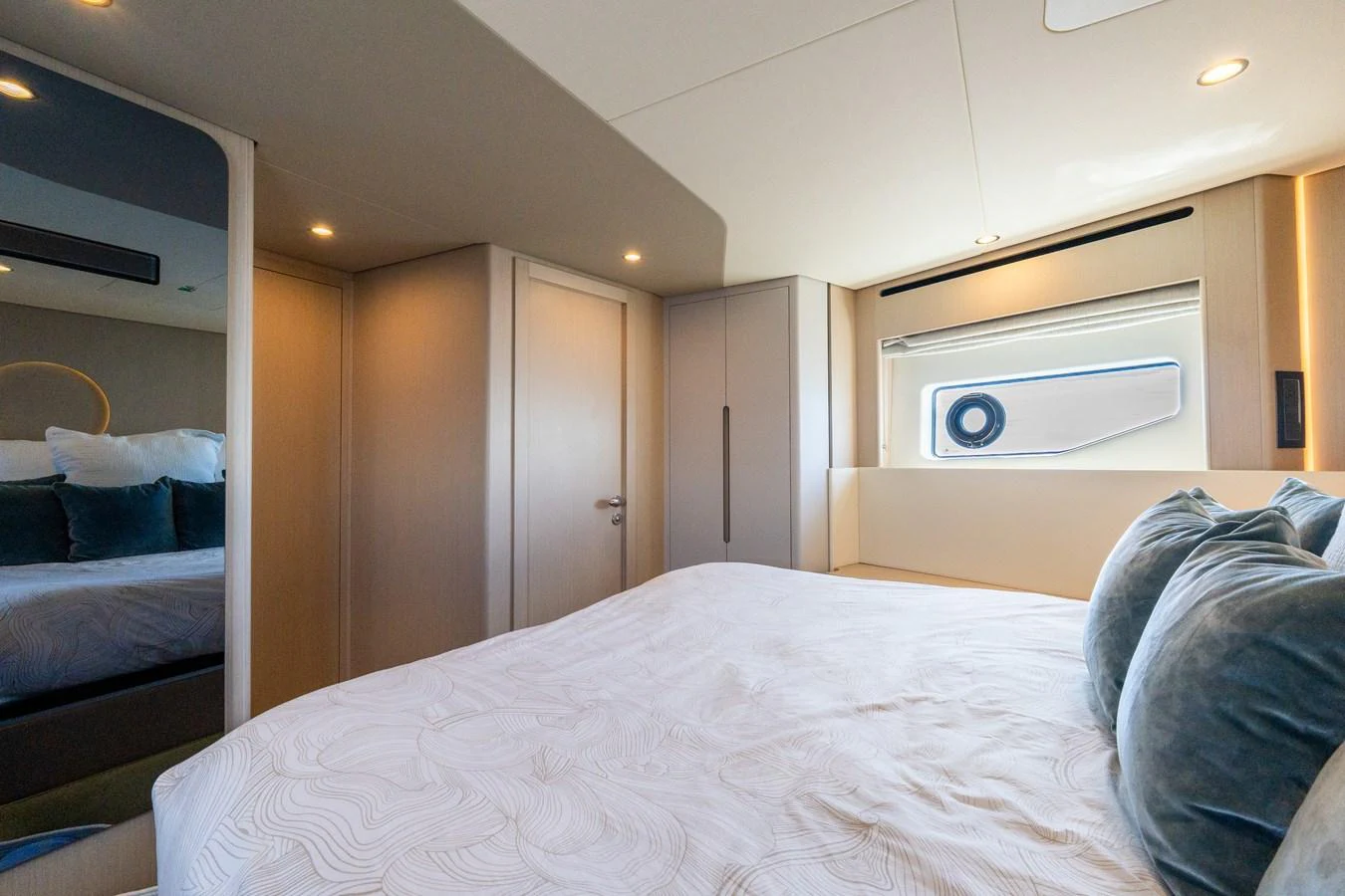 A cozy stateroom featuring a large bed with plush pillows and modern decor. aboard GONE PHISHING Yacht for Sale