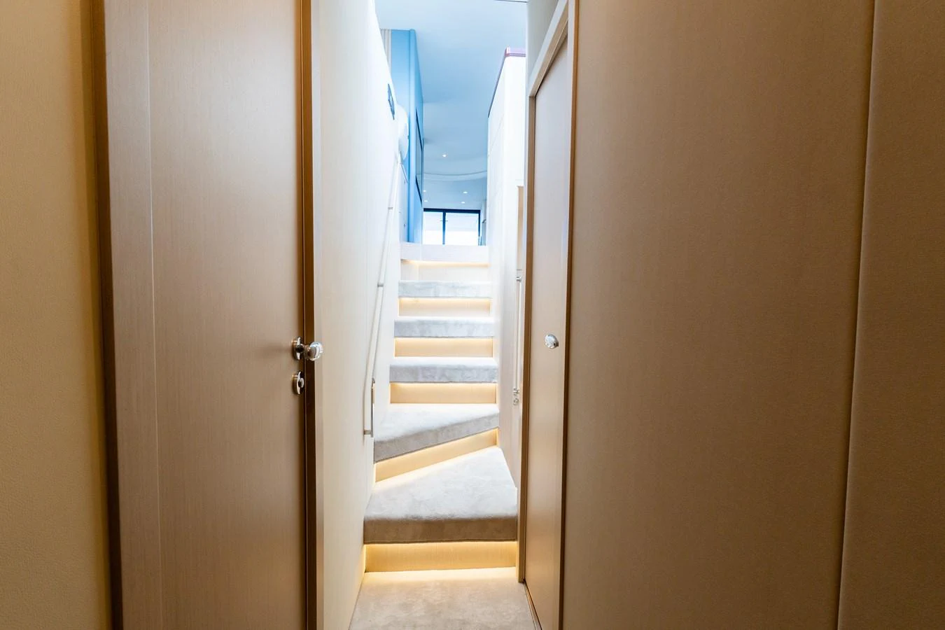 A well-lit staircase with modern design elements leads to the upper deck of the yacht. aboard GONE PHISHING Yacht for Sale