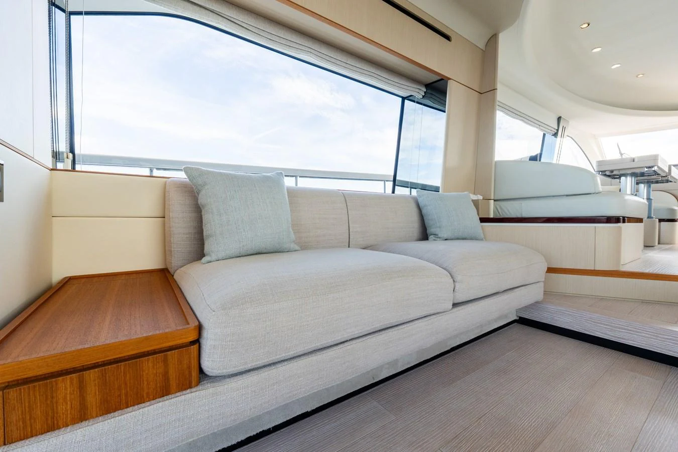 The salon features a comfortable seating area with large windows providing ample natural light. aboard GONE PHISHING Yacht for Sale