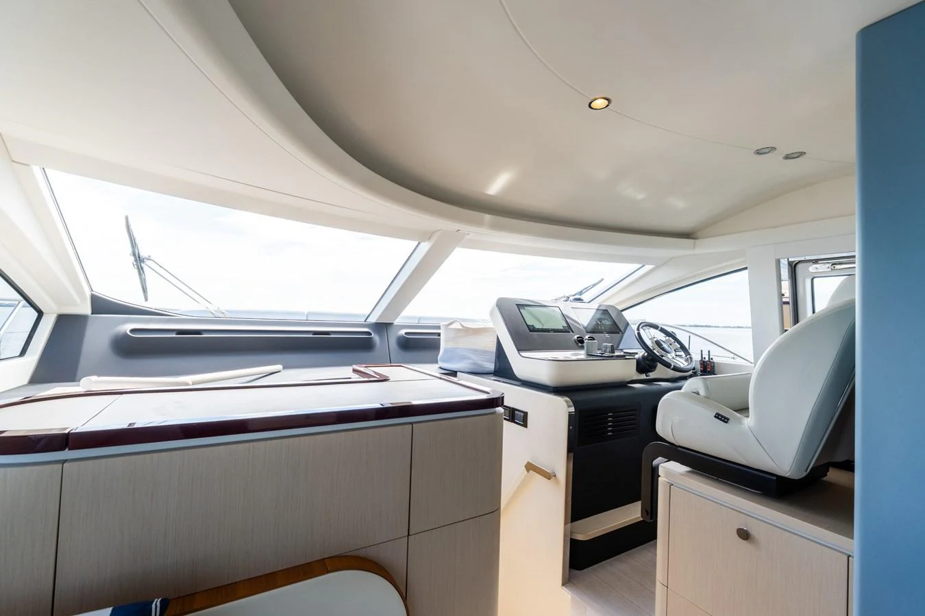 The helm station offers a sleek and modern design with panoramic views. aboard GONE PHISHING Yacht for Sale