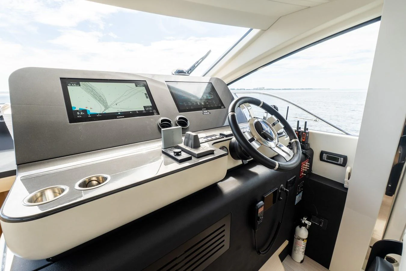 The helm station features modern navigation equipment and a sleek design for optimal control. aboard GONE PHISHING Yacht for Sale