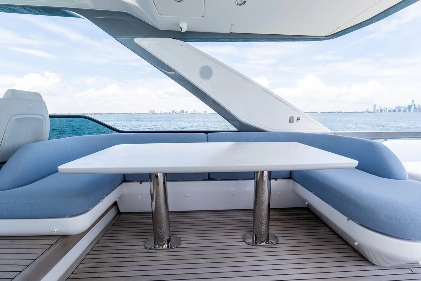 The yacht features an elegant outdoor dining area with a sleek table and comfortable seating, perfect for enjoying meals with a view. aboard GONE PHISHING Yacht for Sale