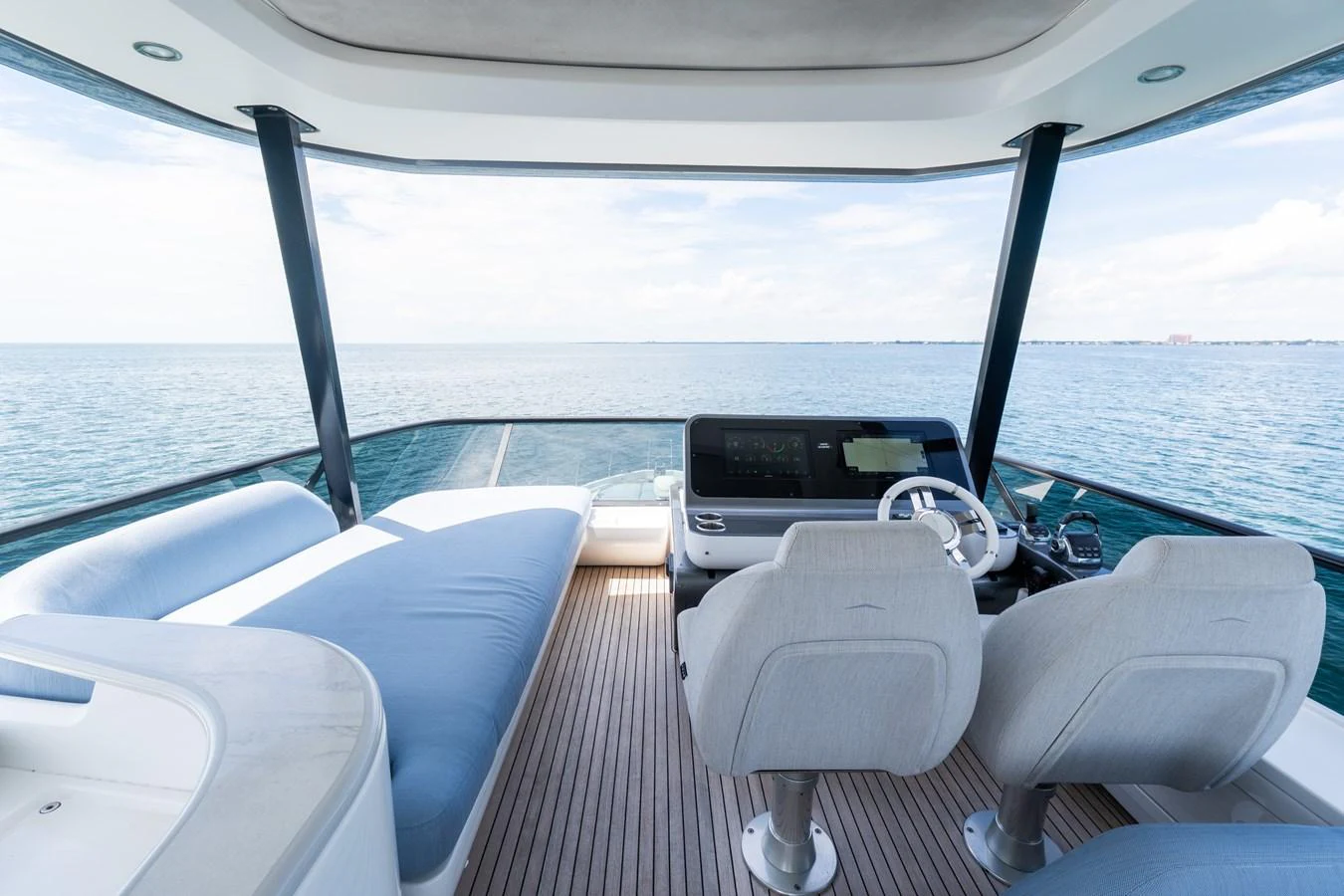 The helm area offers a panoramic view of the sea with comfortable seating and modern navigation equipment. aboard GONE PHISHING Yacht for Sale