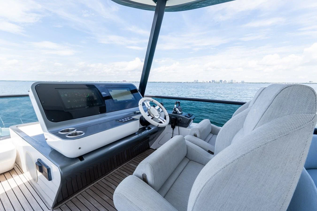 The helm station offers a sleek and modern design with comfortable seating and advanced navigation equipment. aboard GONE PHISHING Yacht for Sale