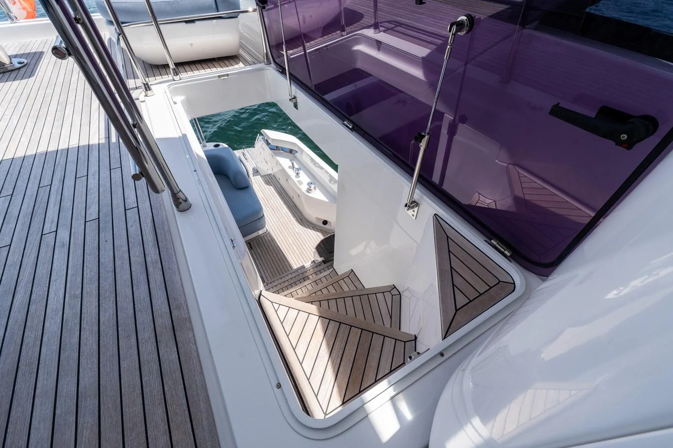 A sleek staircase leads from the deck to the lower level, showcasing modern design and craftsmanship. aboard GONE PHISHING Yacht for Sale