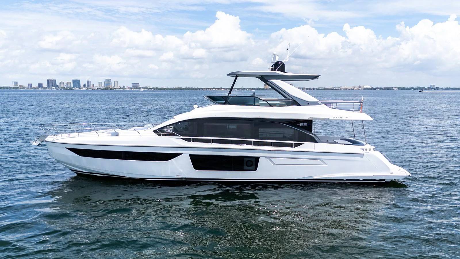 A sleek and modern yacht cruising on calm waters under a bright sky. aboard GONE PHISHING Yacht for Sale