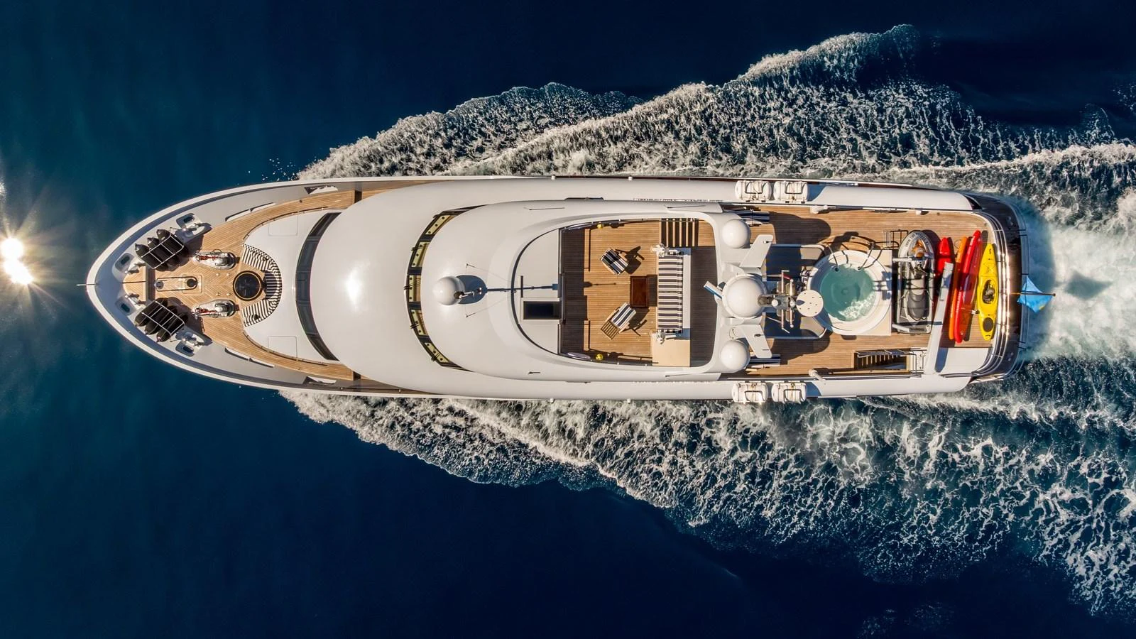 A stunning aerial view of a luxurious yacht cruising through the water, showcasing its spacious deck and elegant design. aboard LA STELLA DEI MARI Yacht for Sale