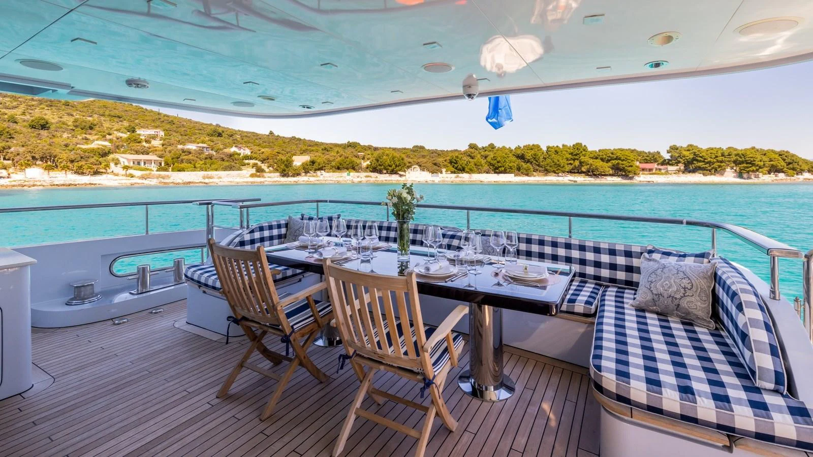 The aft deck features a stylish dining area with comfortable seating and a stunning view of the water. aboard LA STELLA DEI MARI Yacht for Sale