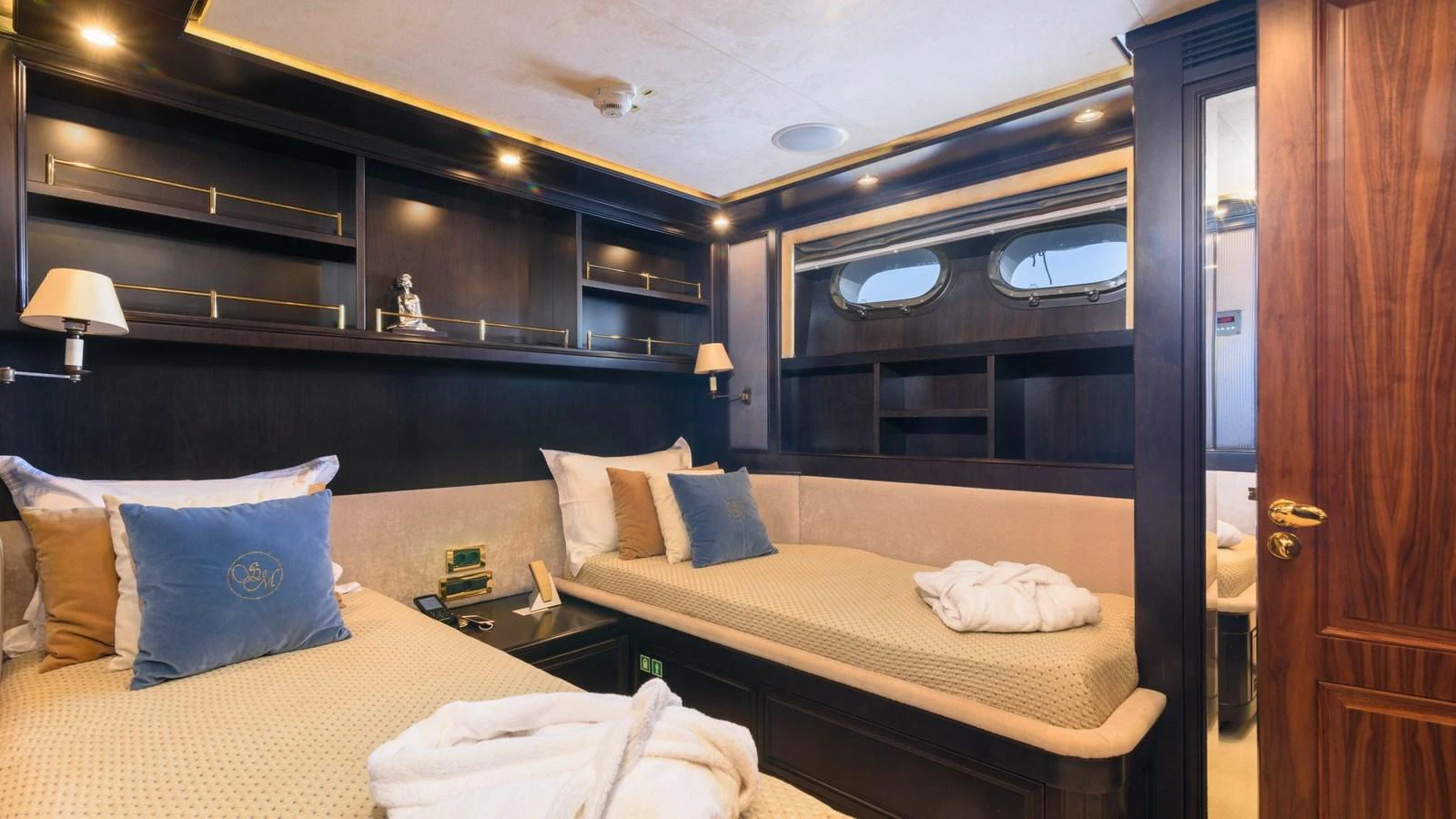 The guest stateroom features twin beds with elegant bedding and warm wood finishes. aboard LA STELLA DEI MARI Yacht for Sale