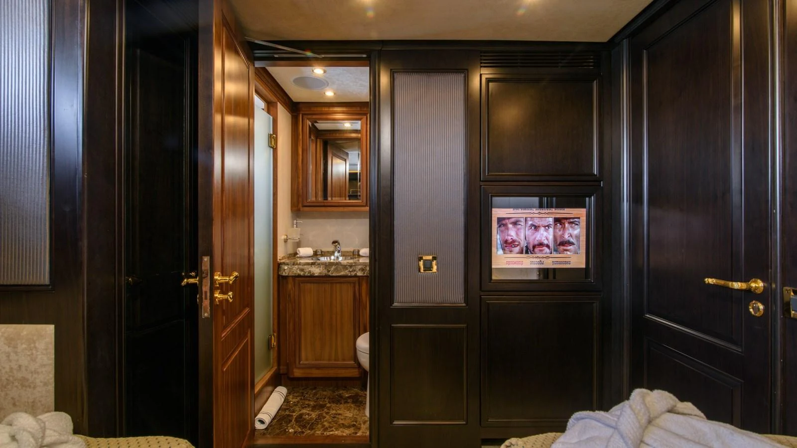 The yacht's interior features a luxurious bathroom and dark wood paneling. aboard LA STELLA DEI MARI Yacht for Sale