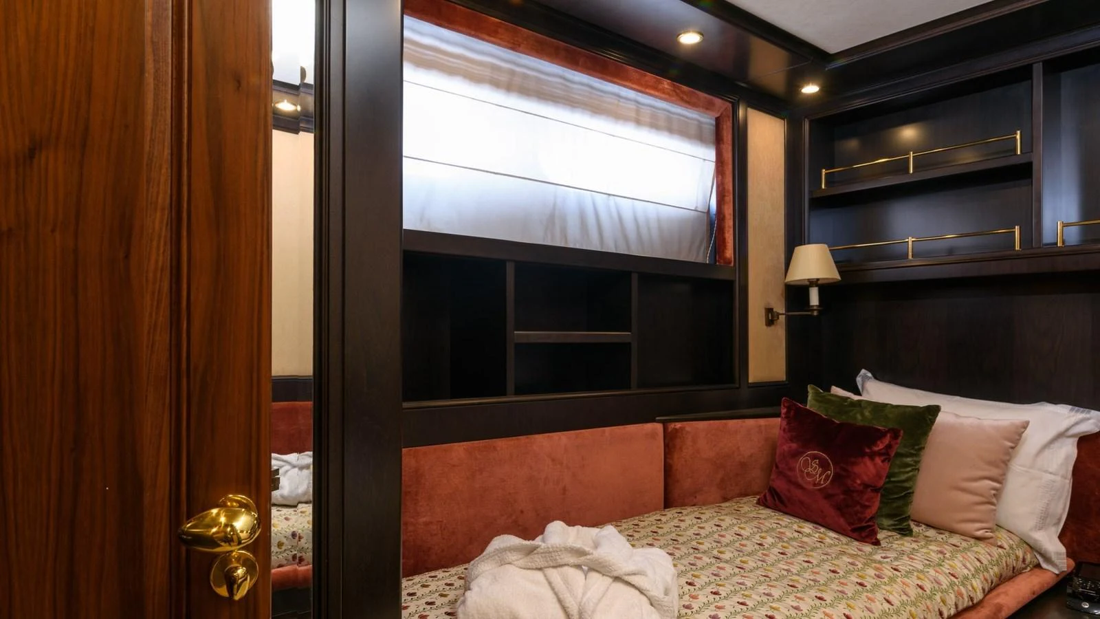 A cozy guest stateroom featuring a comfortable bed with plush pillows and elegant wooden furnishings. aboard LA STELLA DEI MARI Yacht for Sale