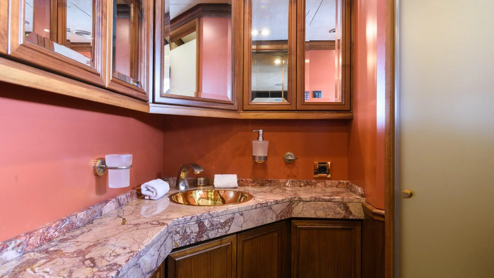 The yacht's bathroom features elegant wooden cabinetry and a marble countertop. aboard LA STELLA DEI MARI Yacht for Sale