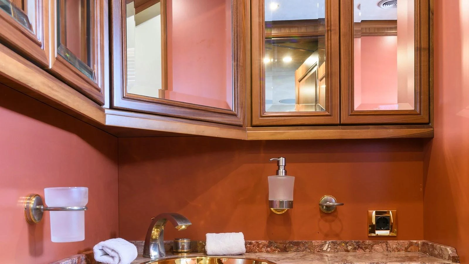 The yacht's bathroom features elegant wooden cabinetry and a marble countertop. aboard LA STELLA DEI MARI Yacht for Sale