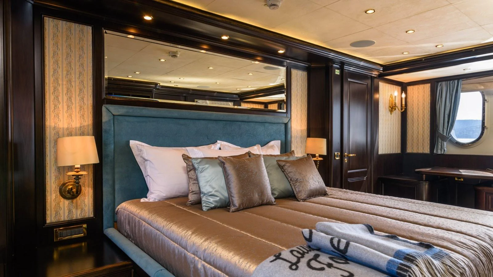 The master stateroom features a luxurious bed with elegant bedding and ambient lighting. aboard LA STELLA DEI MARI Yacht for Sale