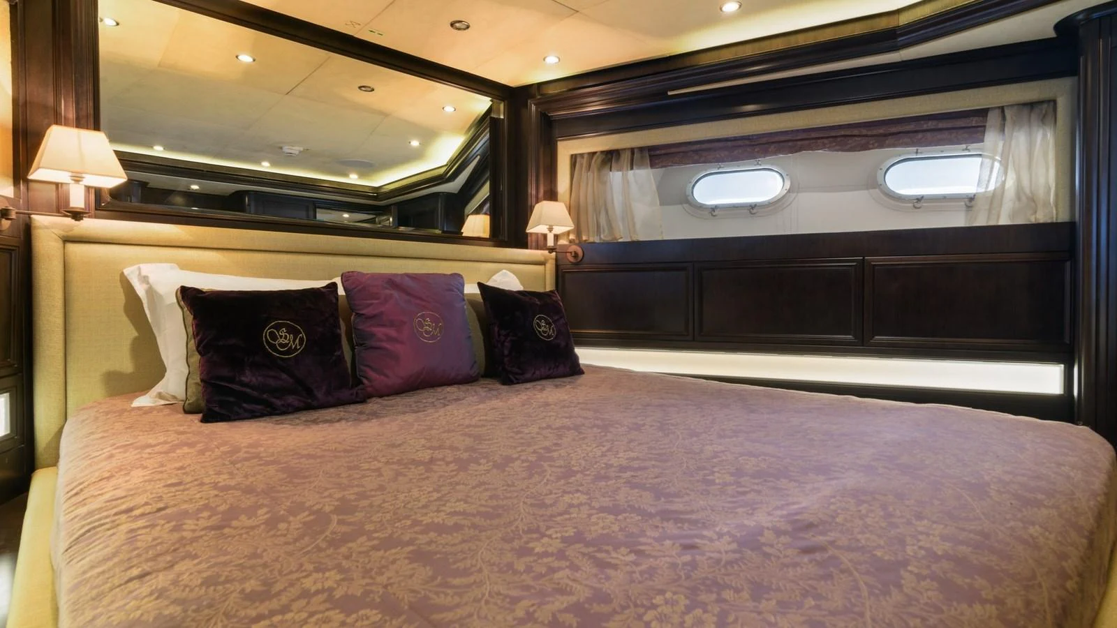 The stateroom features a luxurious bed with elegant bedding and ambient lighting. aboard LA STELLA DEI MARI Yacht for Sale