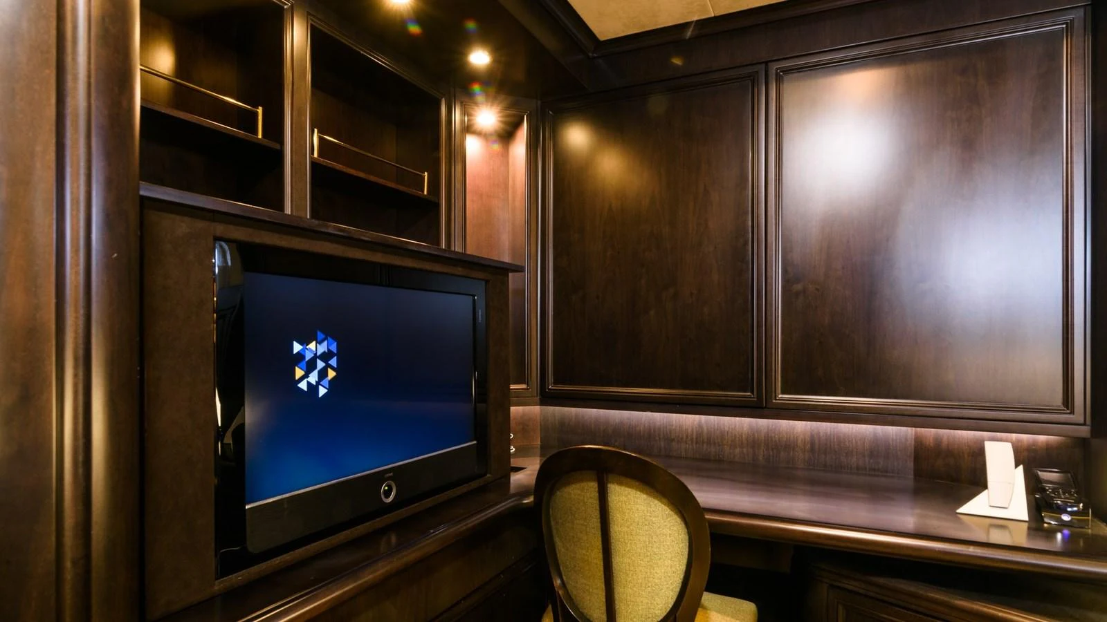The yacht features a sophisticated office space with dark wood paneling and modern amenities. aboard LA STELLA DEI MARI Yacht for Sale