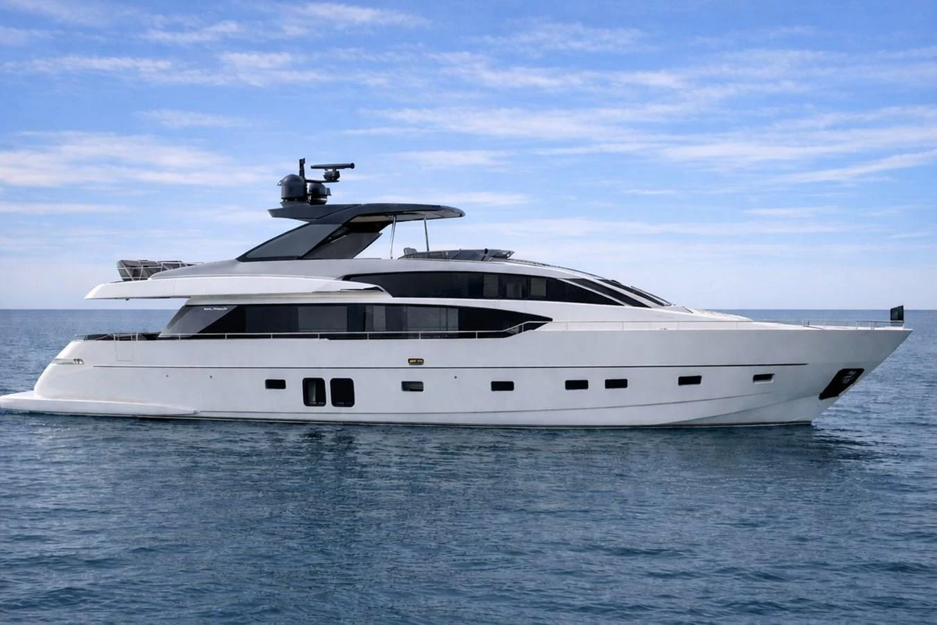 A sleek and modern yacht glides gracefully on calm waters under a clear blue sky. aboard CUT Yacht for Sale