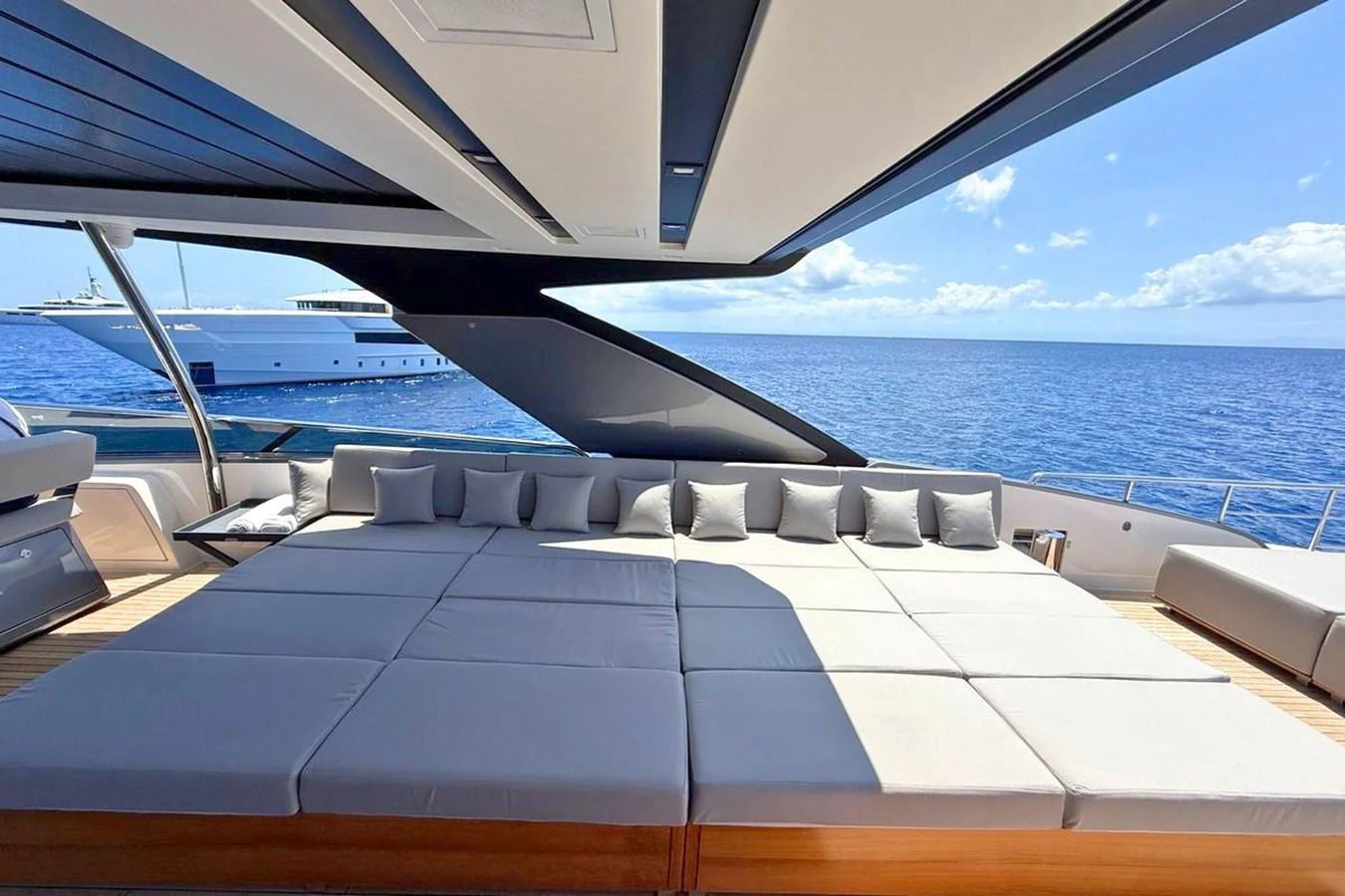 The sundeck features a spacious lounging area with plush cushions, perfect for relaxation while enjoying the ocean view. aboard CUT Yacht for Sale