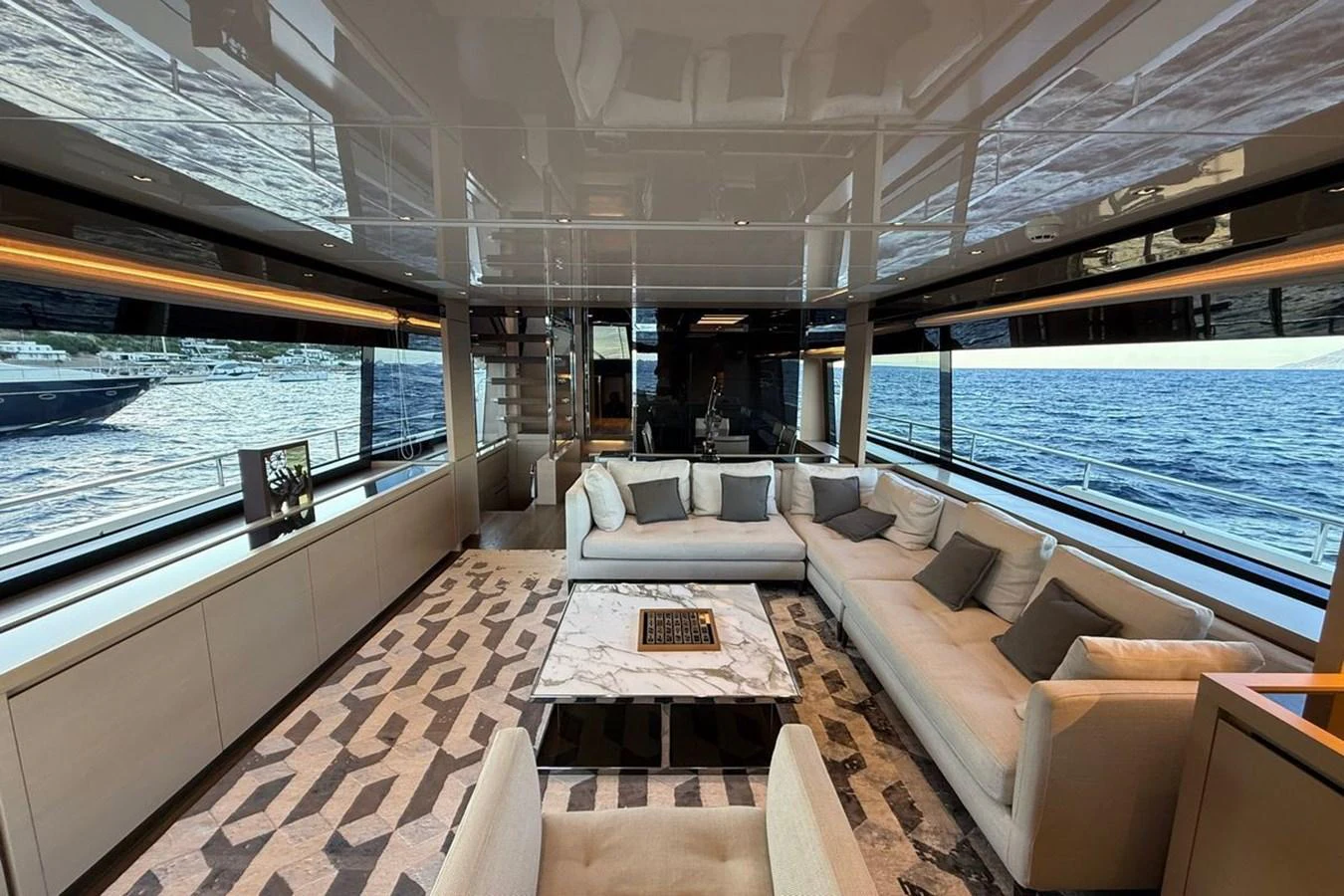 The spacious salon features luxurious seating with panoramic ocean views. aboard CUT Yacht for Sale