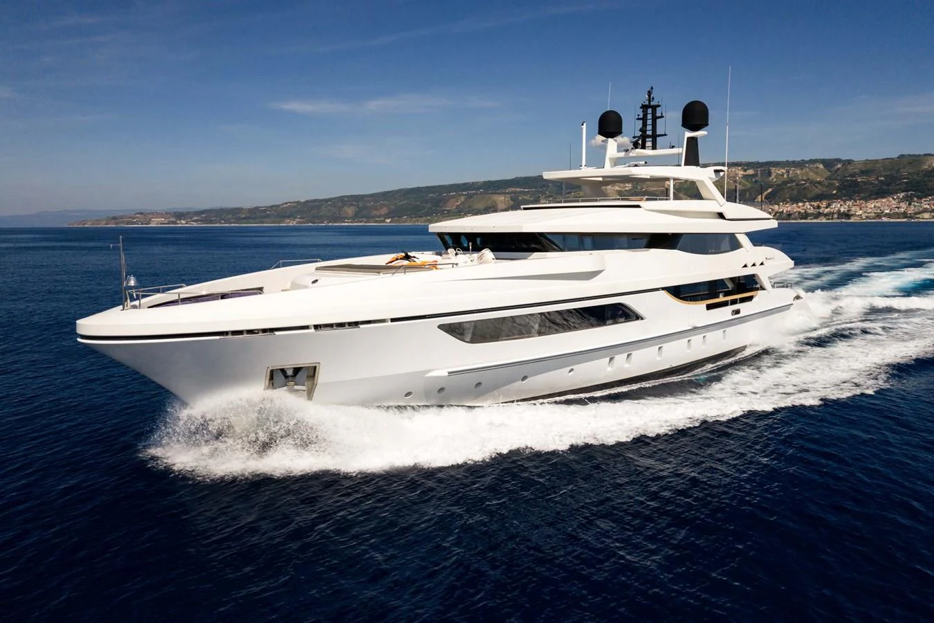 A sleek and modern yacht cruises swiftly through the open water, showcasing its elegant design and luxurious features. aboard MR. T Yacht for Sale