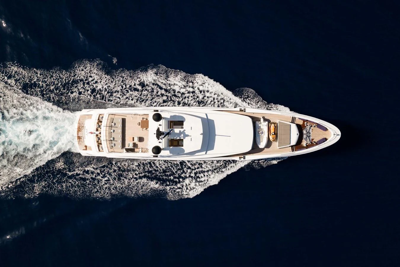 Aerial view of a luxurious yacht cruising through deep blue waters. aboard MR. T Yacht for Sale