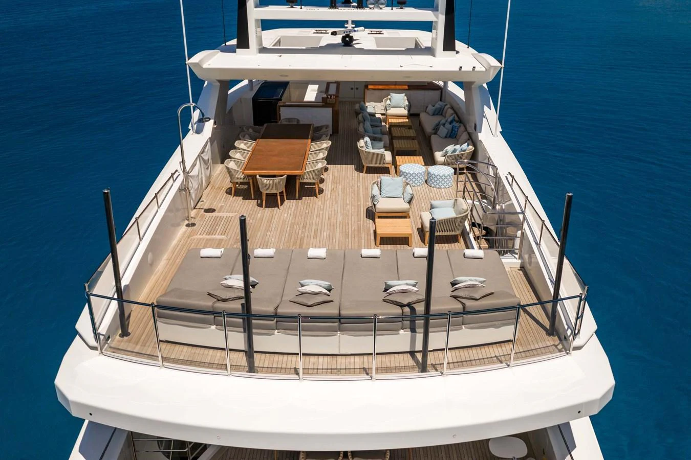 The sundeck features ample seating and lounging areas with stunning views of the water. aboard MR. T Yacht for Sale