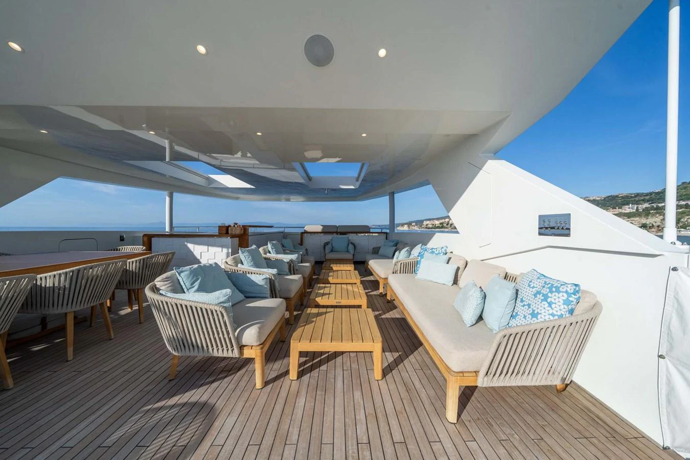 The sundeck features ample seating with plush cushions and a panoramic view. aboard MR. T Yacht for Sale