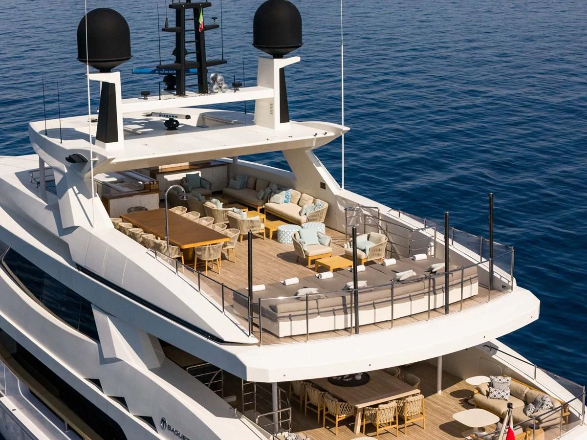 The yacht's expansive sundeck offers luxurious seating and dining areas with stunning ocean views. aboard MR. T Yacht for Sale