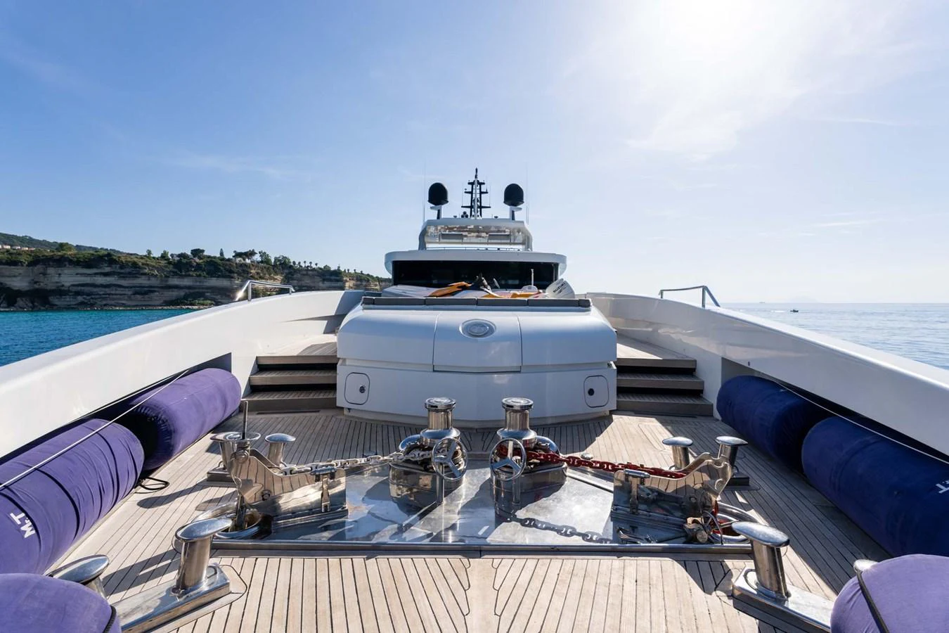 The foredeck of this yacht features a spacious layout with polished anchor equipment and comfortable seating. aboard MR. T Yacht for Sale