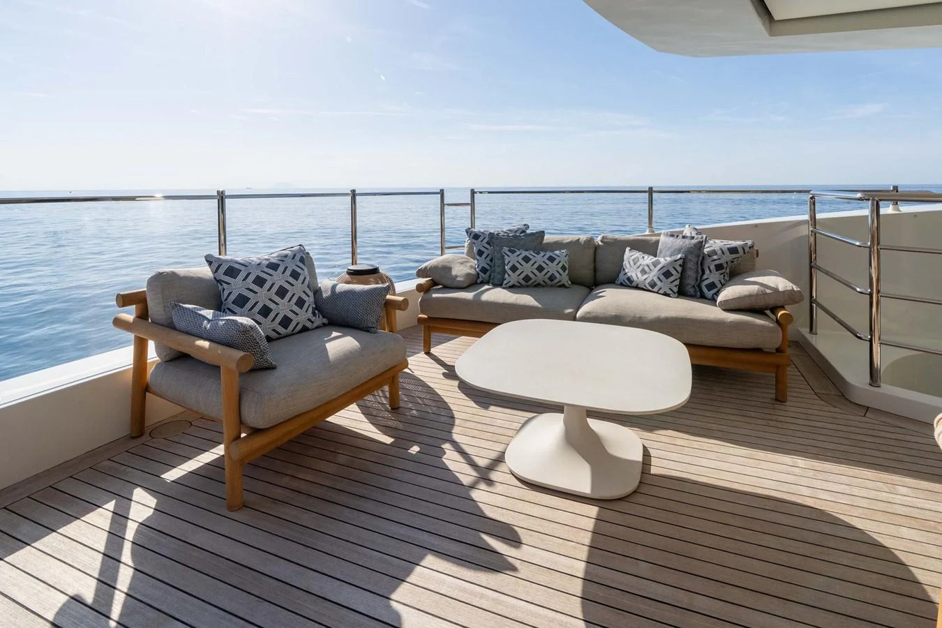 The aft deck features comfortable seating with a stunning ocean view. aboard MR. T Yacht for Sale