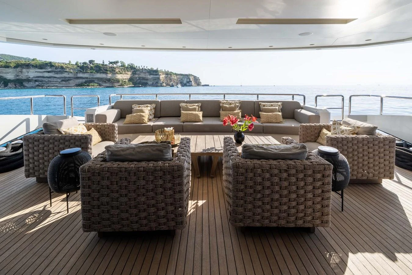 The aft deck features a spacious and luxurious seating area with a stunning ocean view. aboard MR. T Yacht for Sale