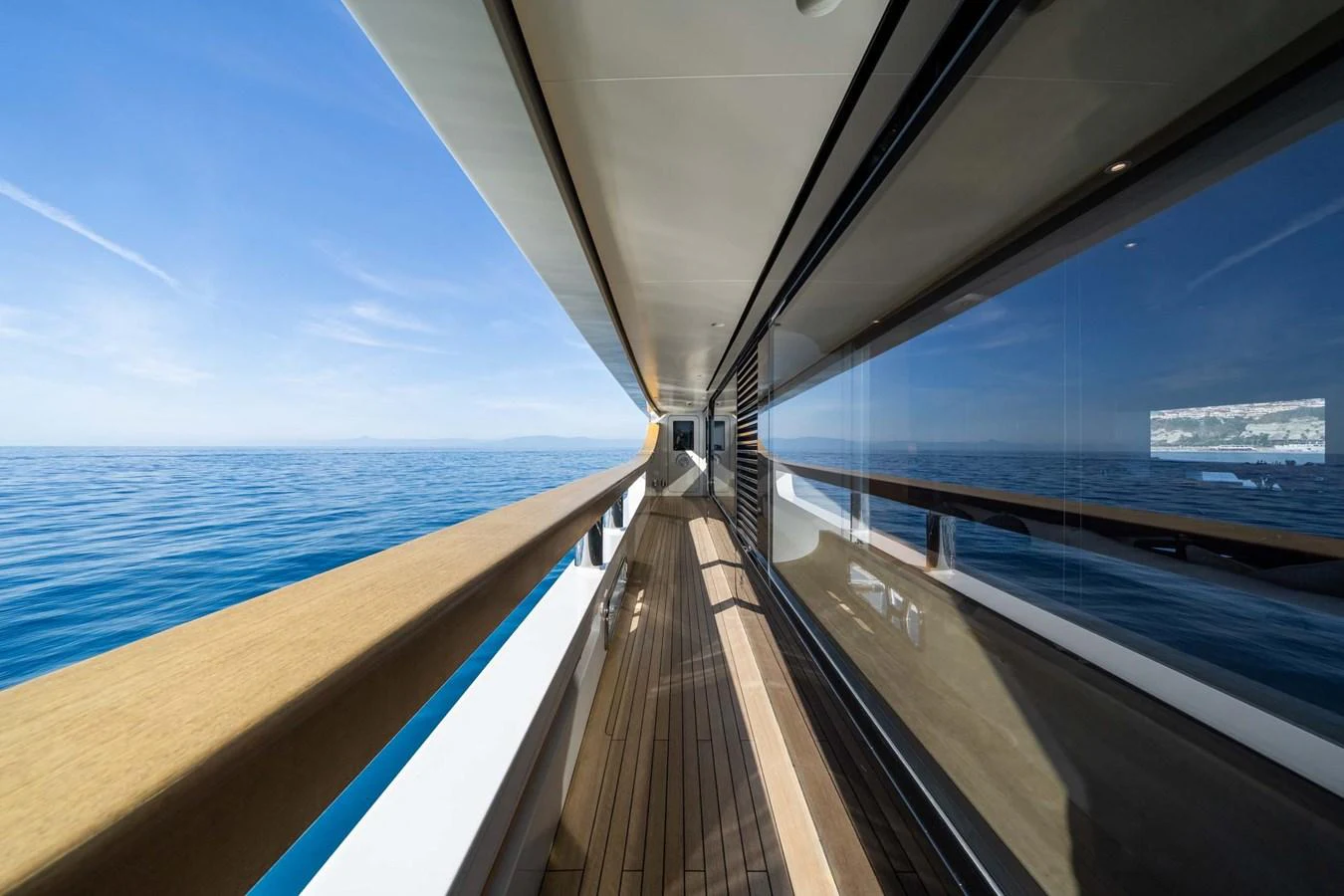 A sleek side deck offers stunning views of the open sea. aboard MR. T Yacht for Sale