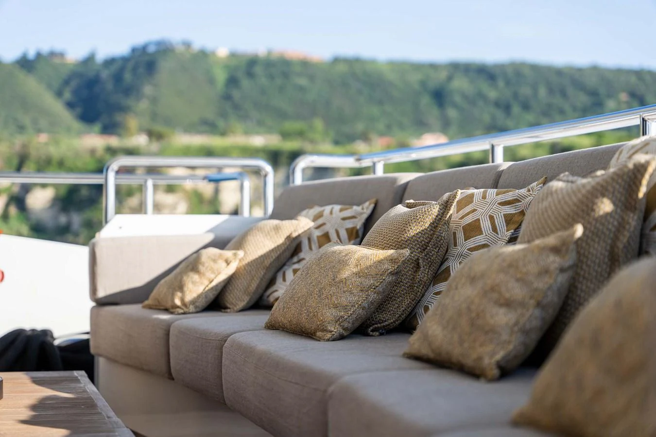 A luxurious outdoor seating area with plush cushions, perfect for relaxation. aboard MR. T Yacht for Sale