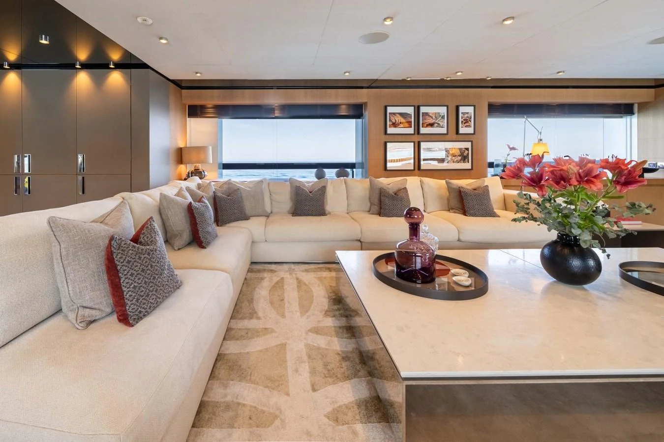 The salon features a spacious and elegant seating area with modern decor and large windows offering stunning views. aboard MR. T Yacht for Sale