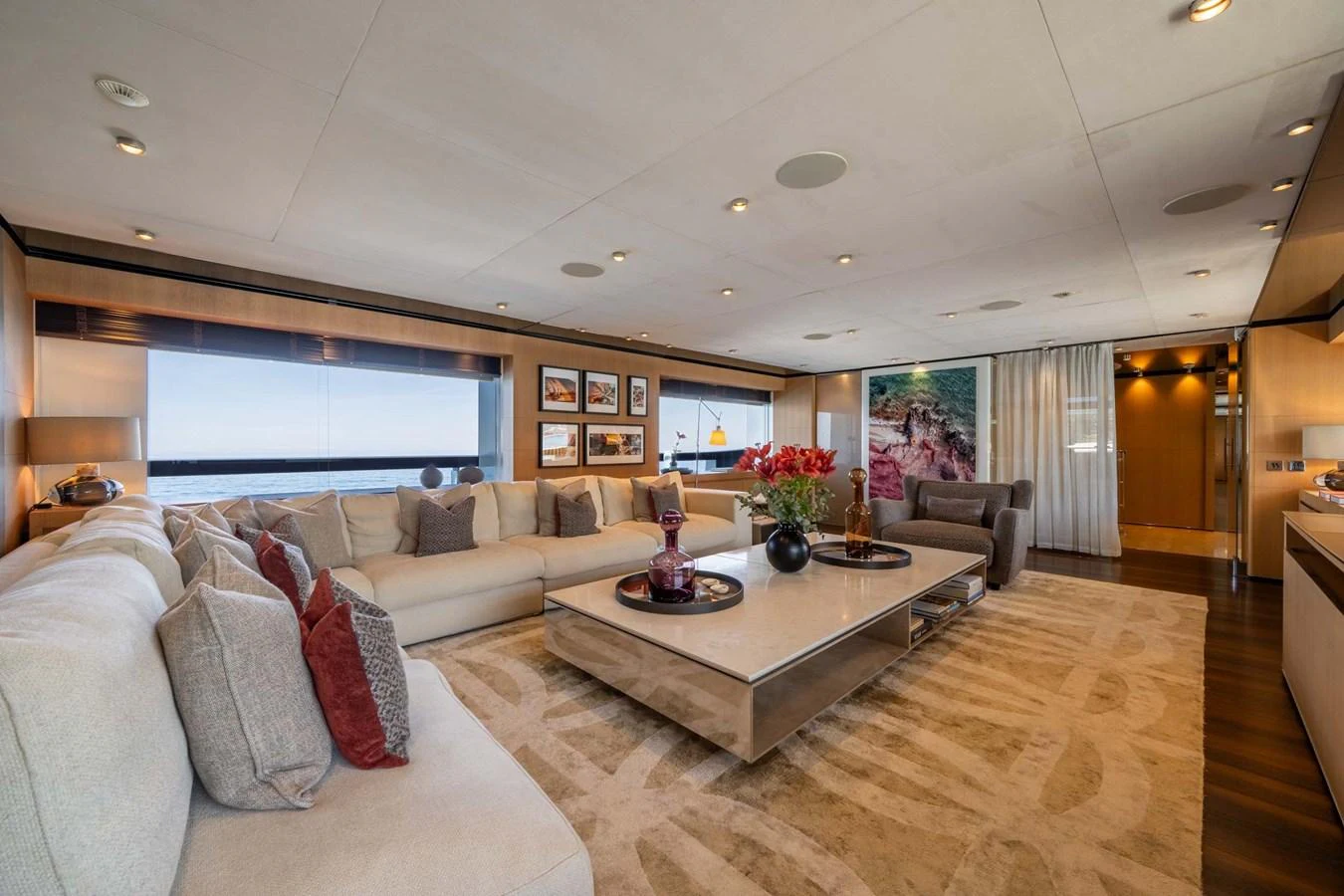 The salon features a spacious and elegantly designed seating area with panoramic windows offering stunning sea views. aboard MR. T Yacht for Sale