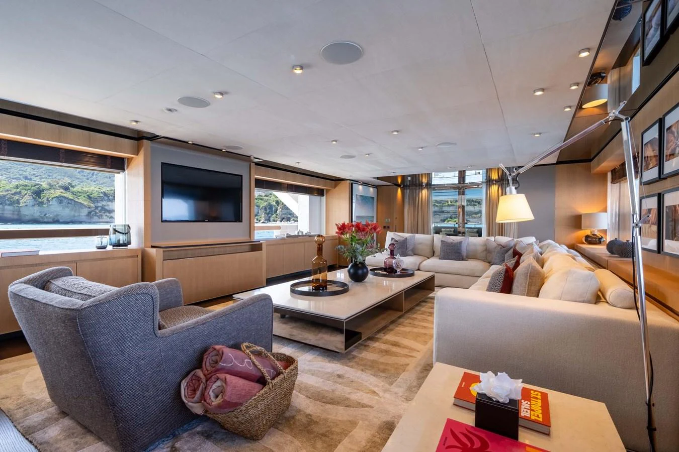 The salon features a spacious and elegantly designed seating area with large windows offering scenic views. aboard MR. T Yacht for Sale