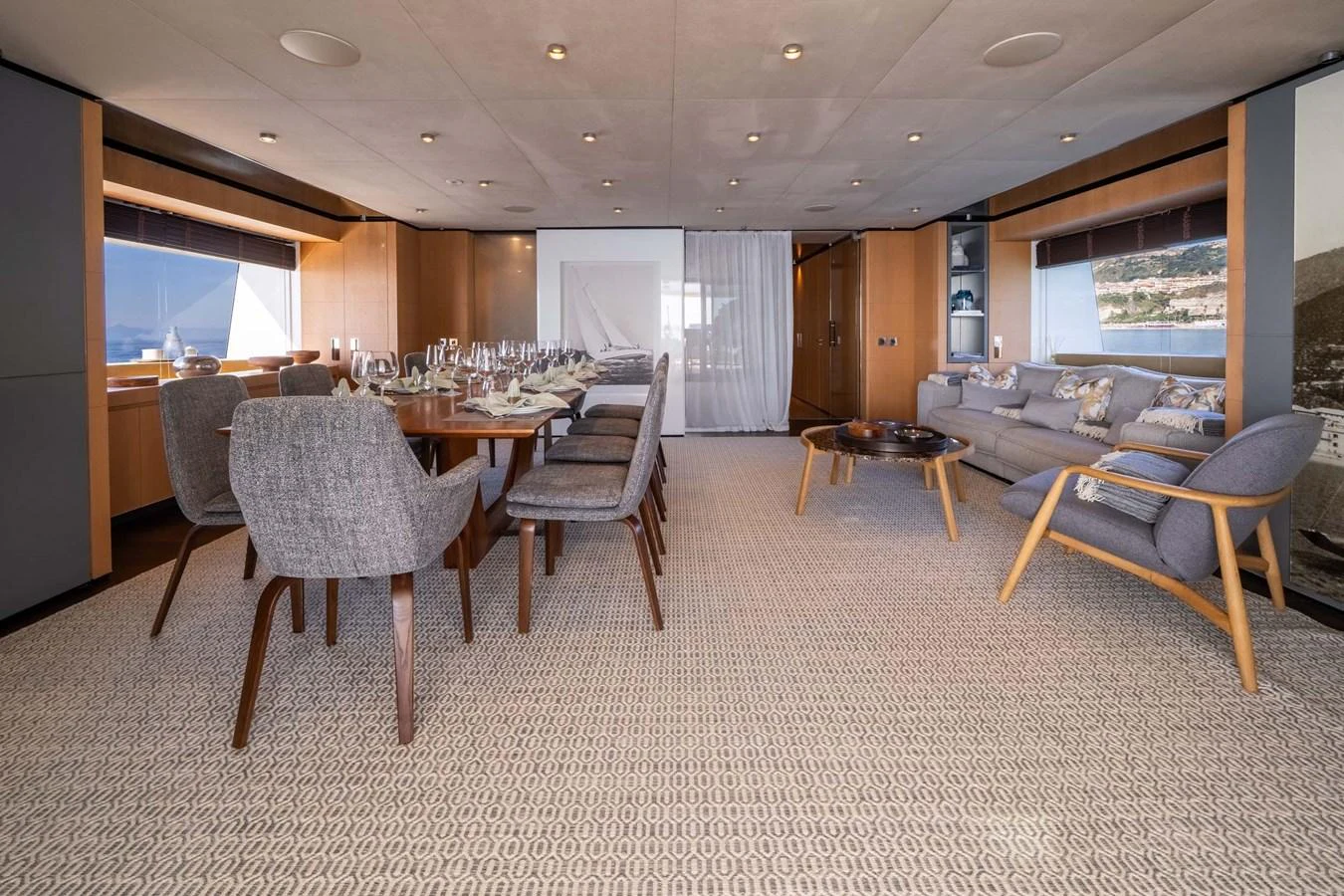 The spacious salon features a dining area and comfortable seating with elegant decor. aboard MR. T Yacht for Sale