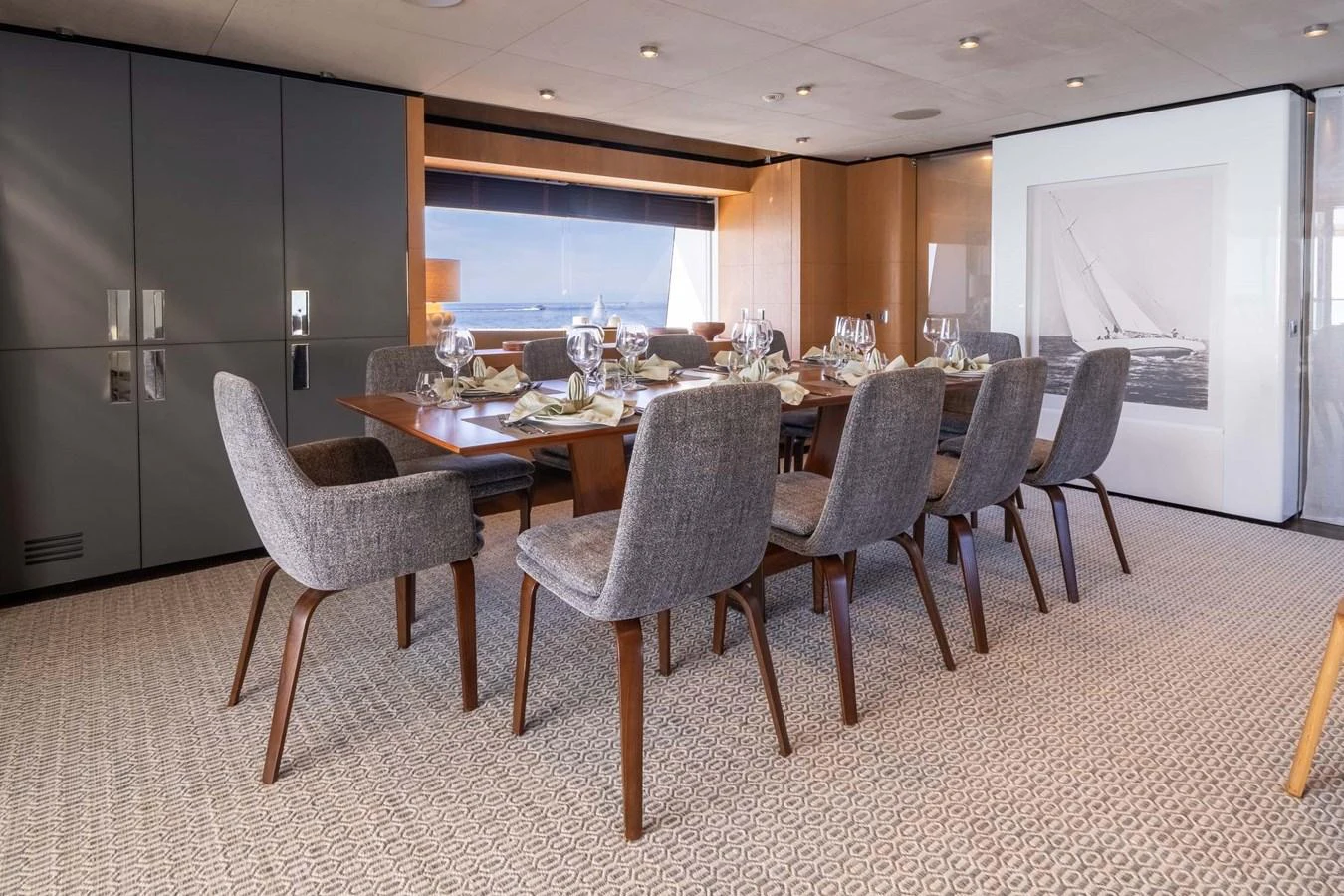 The yacht's dining area features a sophisticated setup with a large table and comfortable chairs, perfect for elegant meals. aboard MR. T Yacht for Sale
