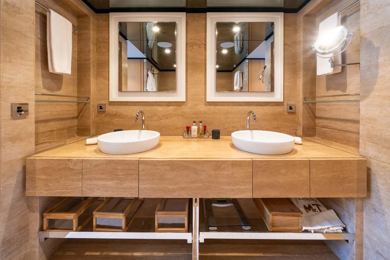 The bathroom features a double vanity with modern fixtures and ample storage space. aboard MR. T Yacht for Sale